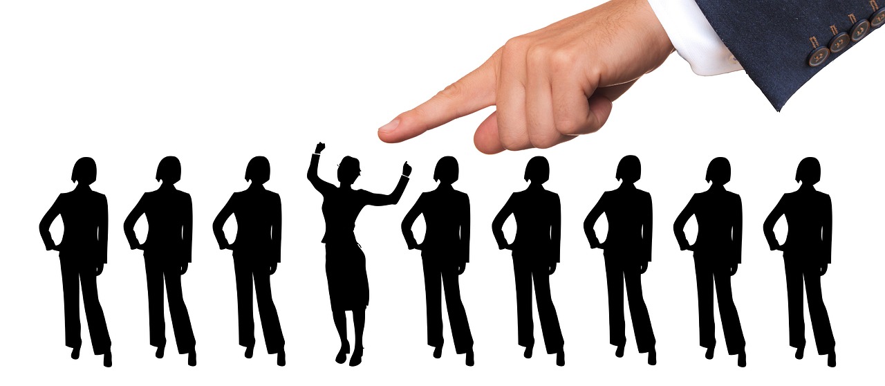 An illustration of a line of job candidates with a hand pointing downward, symbolizing the company's focus on identifying and selecting the best talent for its recruitment services.